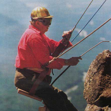 Caretaker Niels Nielsen hanging from the Old Man of the Mountain