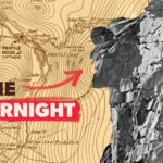 The rugged profile of New Hampshire's Old Man of the Mountain looking out across a dated map of Franconia notch that has the word "Gone Overnight" written on it with an arrow mysteriously pointed towards the stone profile